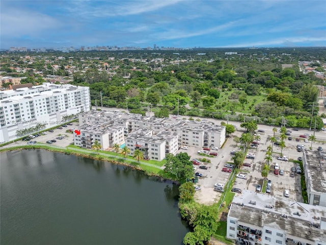 drone / aerial view featuring a city view and a water view