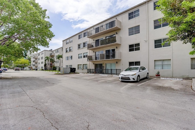 view of building exterior with uncovered parking