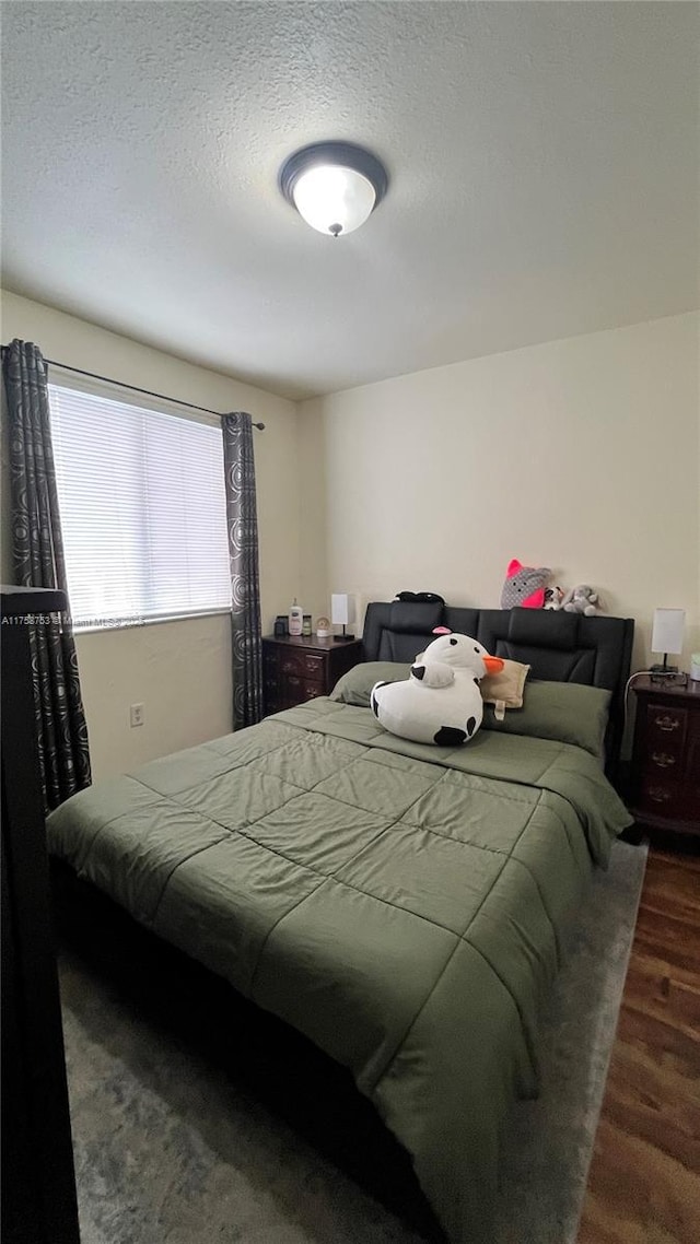 2462 SE 15th Pl Unit 339, Homestead, FL 33035 - bedroom with a textured ceiling and wood finished floors