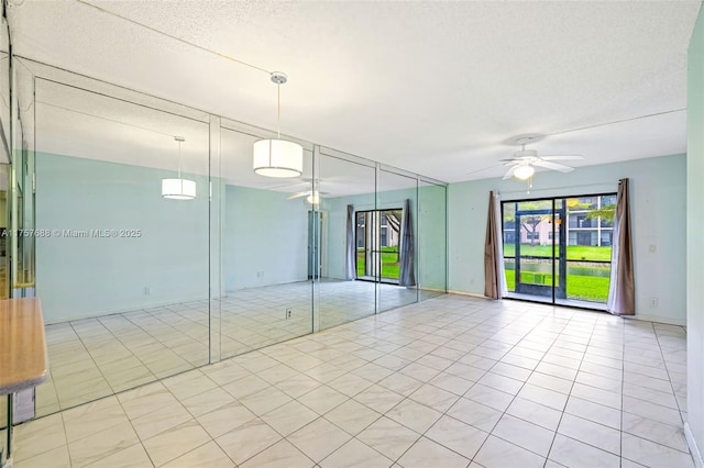 interior space featuring tile patterned floors and ceiling fan