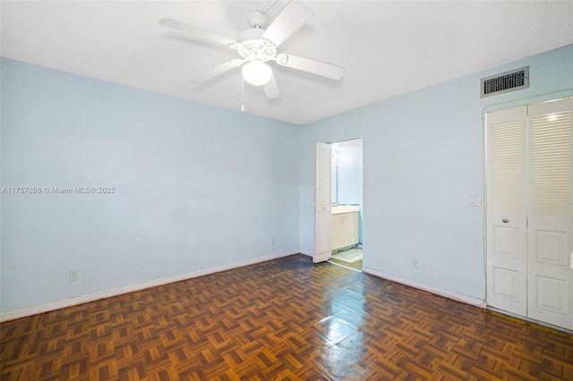 unfurnished bedroom with visible vents, a ceiling fan, ensuite bath, a closet, and baseboards