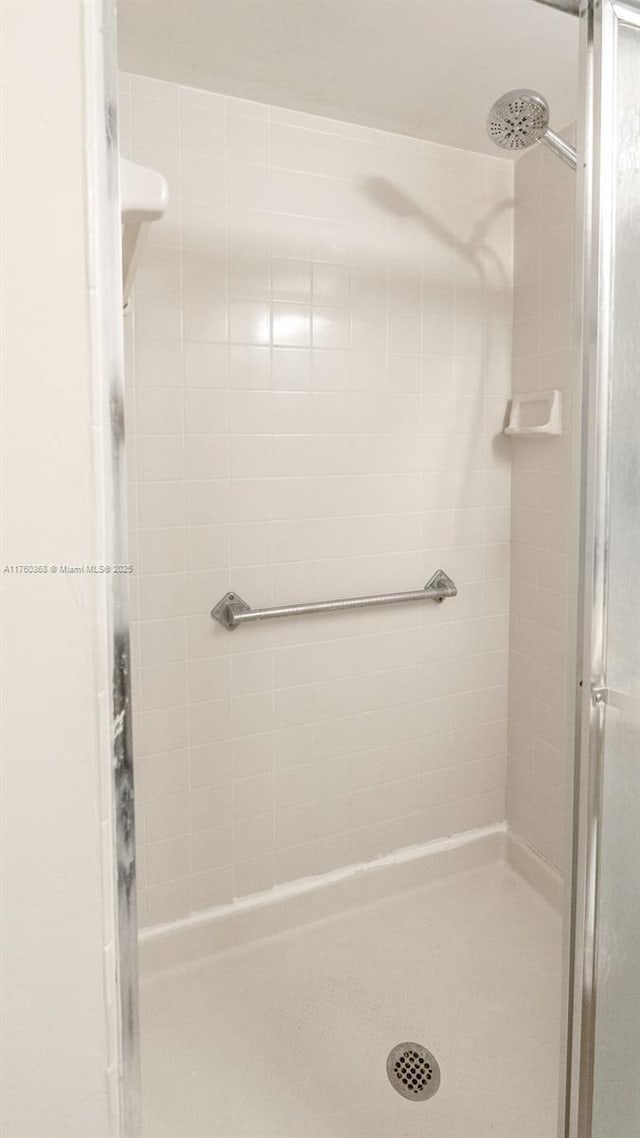 full bath with a shower stall