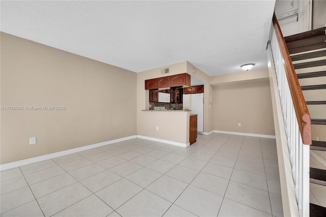 kitchen featuring visible vents, tasteful backsplash, white appliances, a peninsula, and light tile patterned floors