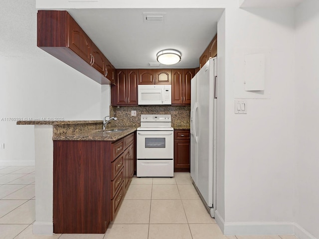 8585 NW 6th Ln Unit 9-208, Miami, FL 33126 - kitchen featuring white appliances, light tile patterned floors, dark stone countertops, tasteful backsplash, and a peninsula