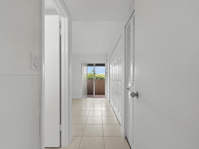 8585 NW 6th Ln Unit 9-208, Miami, FL 33126 - hall featuring a textured ceiling and light tile patterned flooring