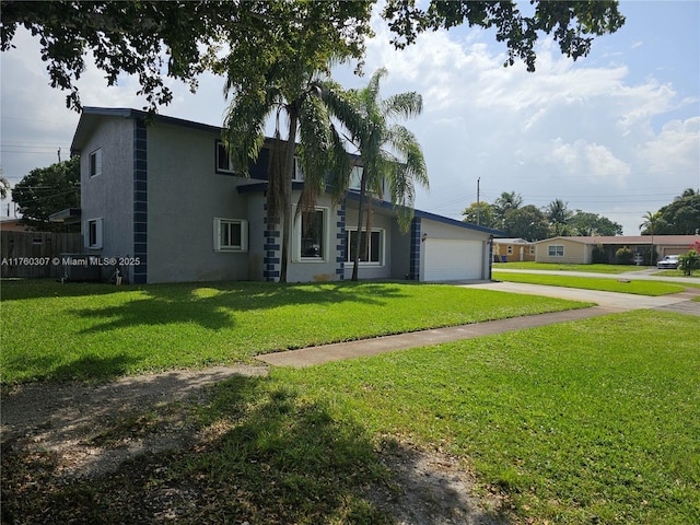 view of front of house featuring a front lawn, a garage, driveway, and stucco siding