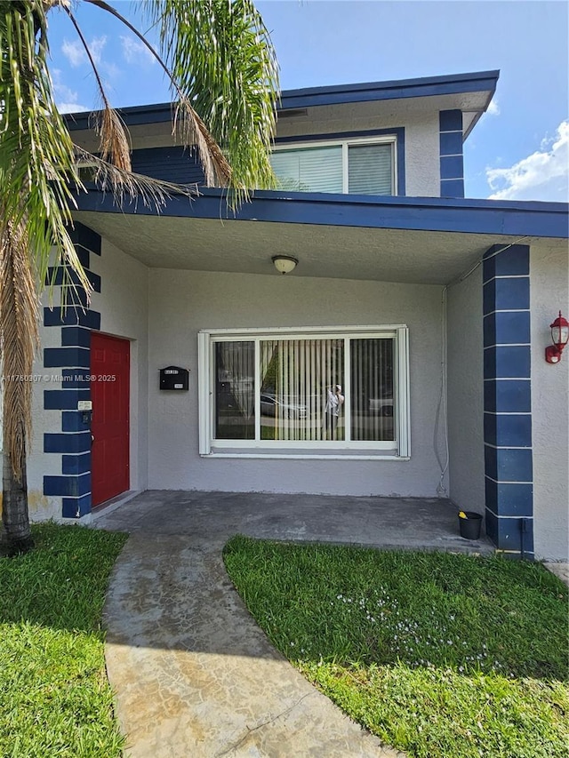 doorway to property with stucco siding