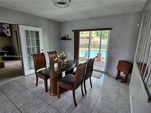 dining area with french doors and light tile patterned flooring