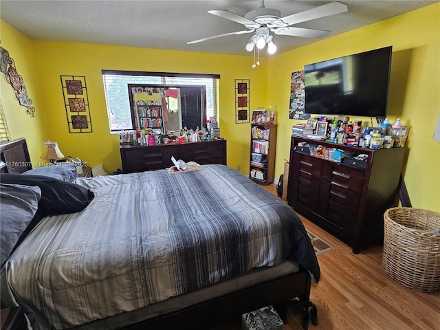 bedroom with wood finished floors and ceiling fan