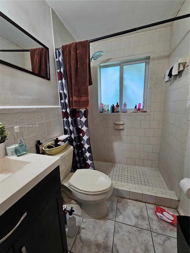 full bath with vanity, tile walls, toilet, and a stall shower