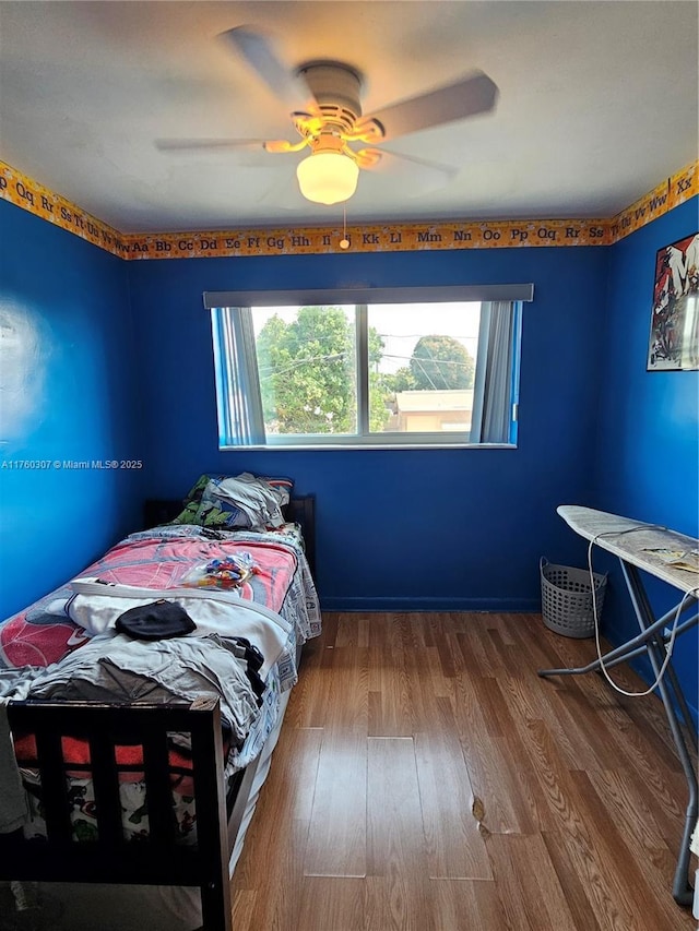 bedroom featuring wood finished floors and a ceiling fan