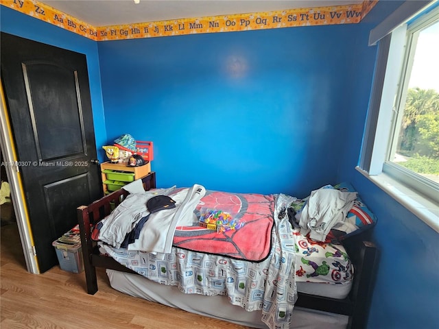 bedroom with wood finished floors