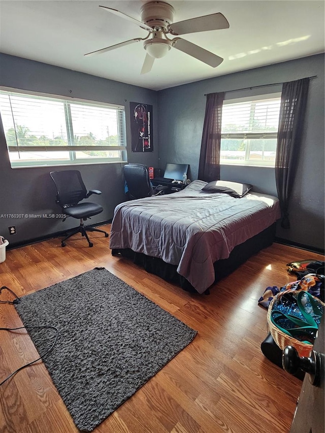 bedroom featuring wood finished floors and a ceiling fan