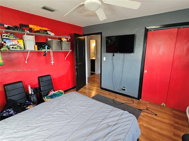 bedroom with visible vents, ceiling fan, and wood finished floors