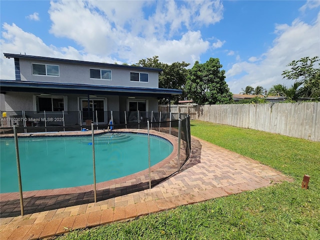 view of pool with a patio area, a lawn, a fenced backyard, and a fenced in pool