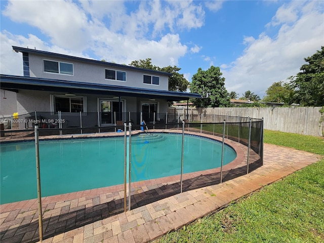 view of pool with a fenced in pool, a yard, and fence