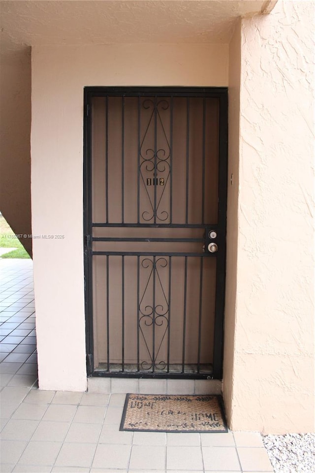 view of exterior entry with stucco siding