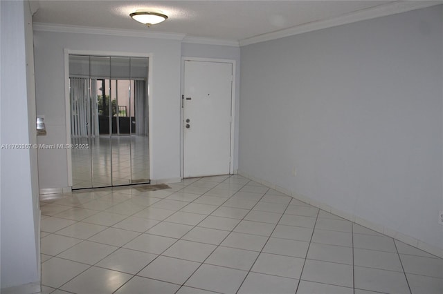 unfurnished room featuring light tile patterned floors and crown molding