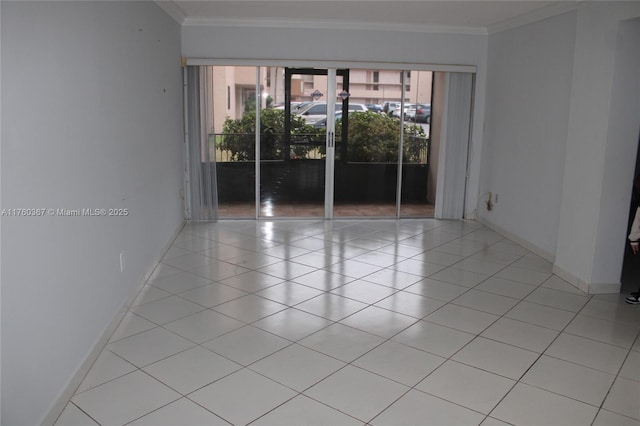 unfurnished room featuring tile patterned floors, crown molding, baseboards, and french doors