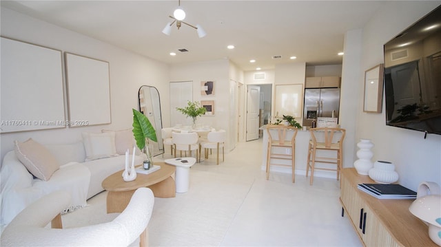 living room featuring recessed lighting, visible vents, and light floors