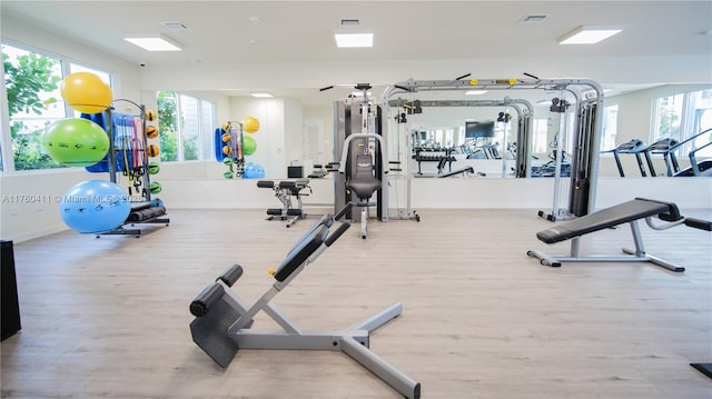 gym with visible vents, baseboards, and wood finished floors