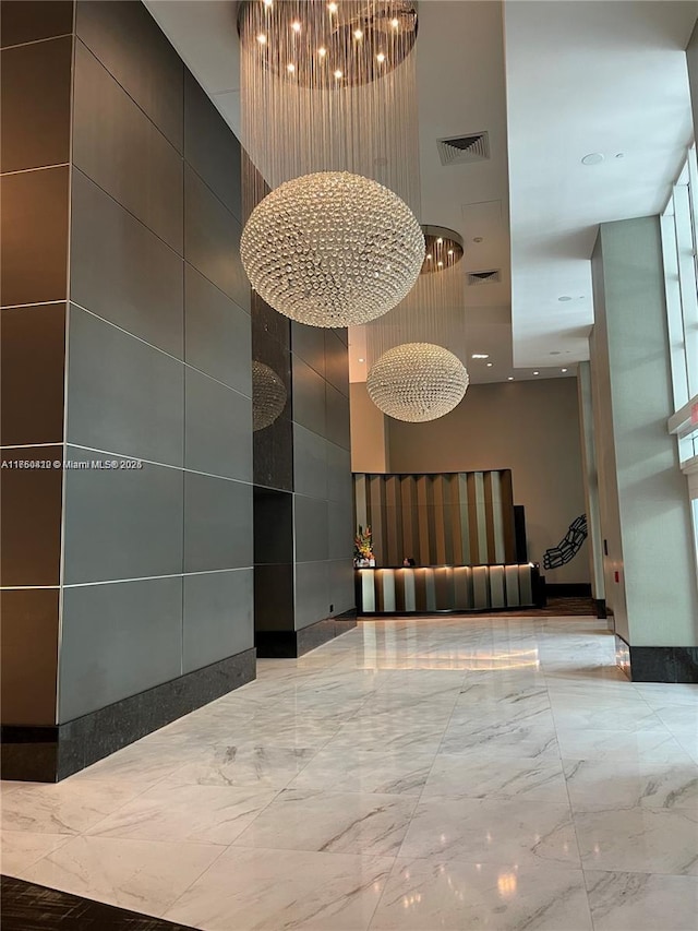 reception area featuring a notable chandelier and visible vents