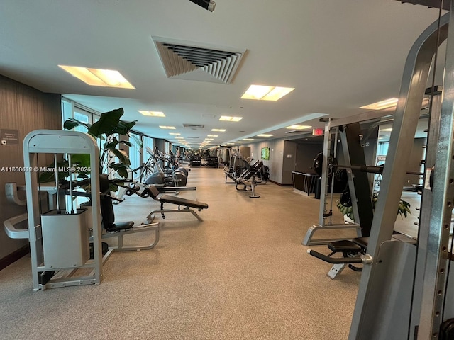 exercise room featuring arched walkways and visible vents