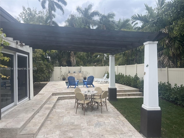 view of patio featuring a pergola and fence