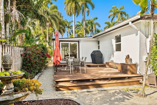 1134 Van Buren St, Hollywood, FL 33019 - exterior space with stucco siding, outdoor dining area, a deck, and fence