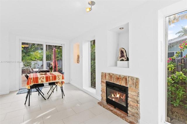 1134 Van Buren St, Hollywood, FL 33019 - dining area with baseboards, a healthy amount of sunlight, and a fireplace