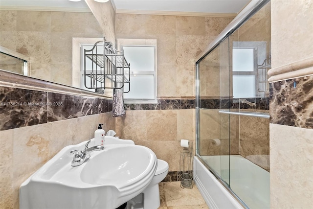 1134 Van Buren St, Hollywood, FL 33019 - bathroom featuring a sink, ornamental molding, tile walls, toilet, and combined bath / shower with glass door