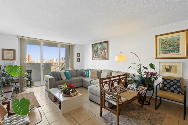 living room featuring expansive windows, a textured ceiling, a city view, and light tile patterned flooring