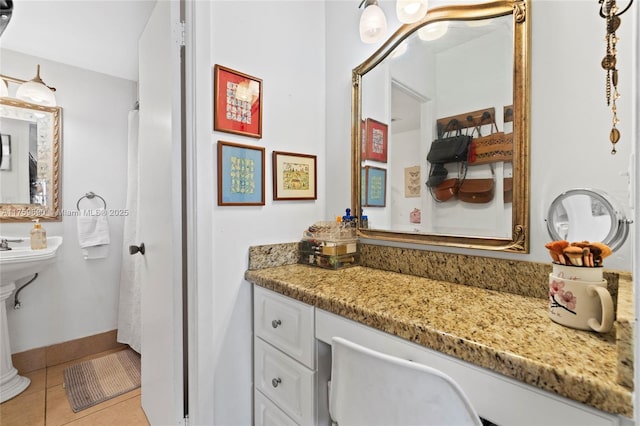 bathroom with tile patterned floors and baseboards