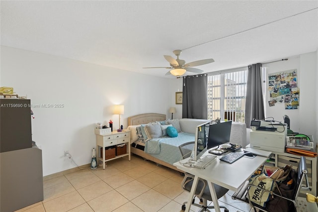 bedroom featuring light tile patterned floors, baseboards, and a ceiling fan