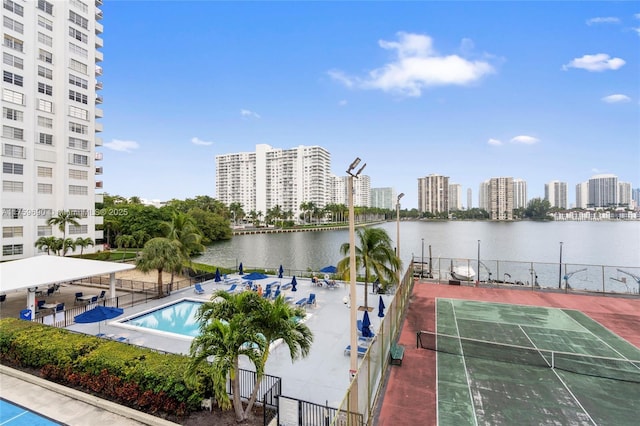 property view of water featuring a view of city and fence