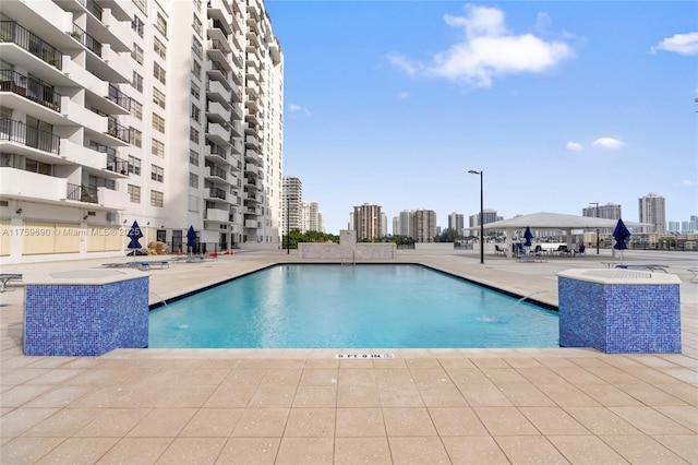 pool with a patio and a city view