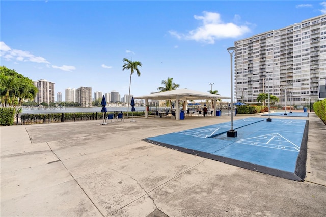 view of home's community with shuffleboard and a view of city