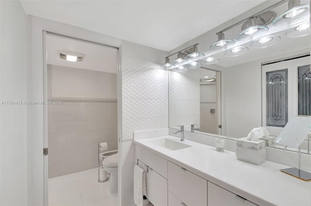 full bath with toilet, tile walls, vanity, and tile patterned flooring