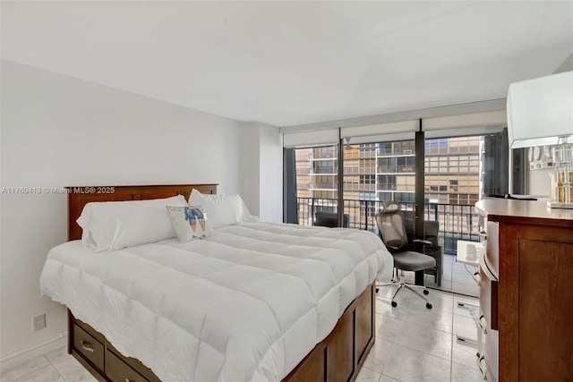 bedroom featuring light tile patterned flooring, baseboards, and access to outside