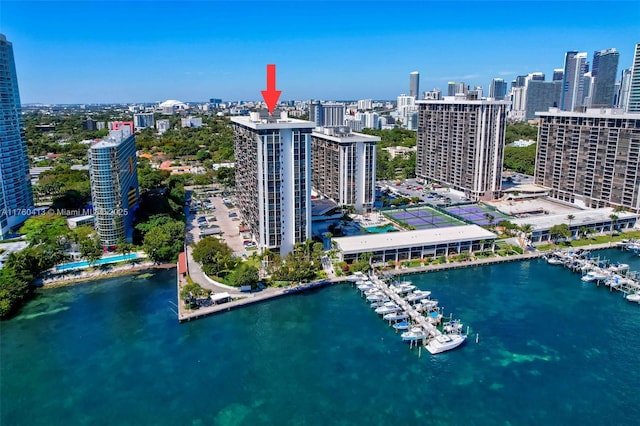 birds eye view of property with a view of city and a water view