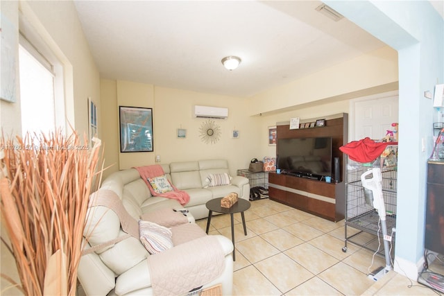 living area featuring light tile patterned floors, visible vents, and a wall mounted air conditioner