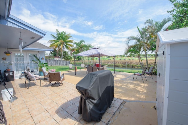 view of patio / terrace featuring a gazebo, area for grilling, a fenced backyard, and outdoor lounge area