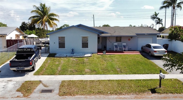 ranch-style home with stucco siding, a front lawn, fence, concrete driveway, and an attached garage