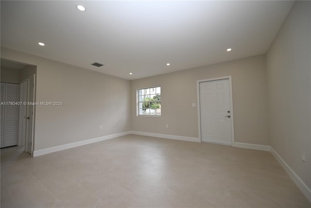 unfurnished room with recessed lighting, visible vents, and baseboards