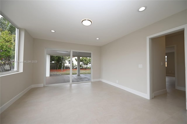 empty room featuring recessed lighting and baseboards