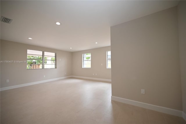 unfurnished room with recessed lighting, baseboards, and visible vents