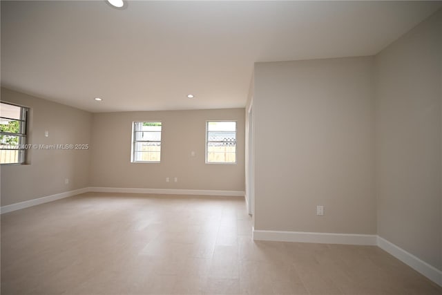 unfurnished room featuring recessed lighting and baseboards