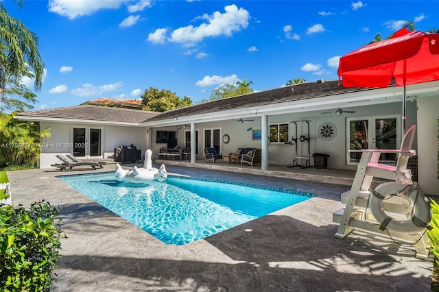 rear view of property featuring french doors, a patio area, a ceiling fan, and stucco siding