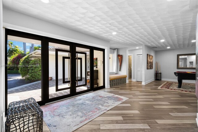 foyer featuring baseboards, recessed lighting, wood finished floors, and pool table