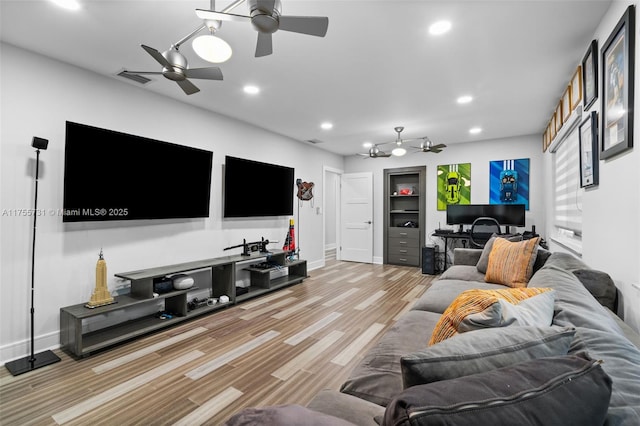 living room featuring visible vents, baseboards, ceiling fan, light wood-type flooring, and recessed lighting